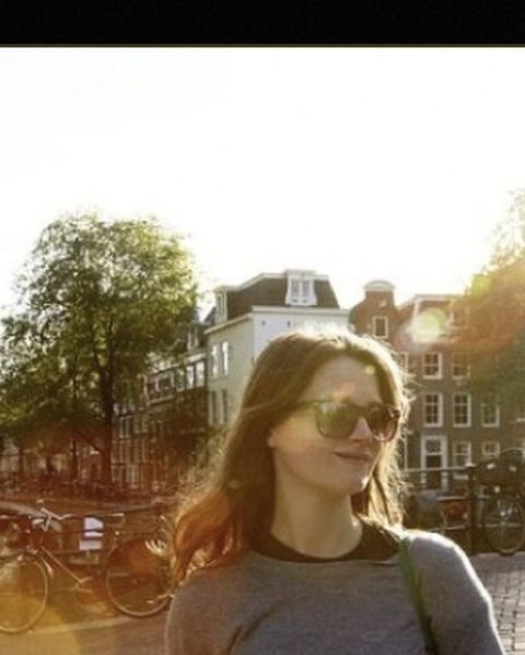 Surprise getaway in Europe — a traveler on a bridge at sunset, golden light, an air of escape