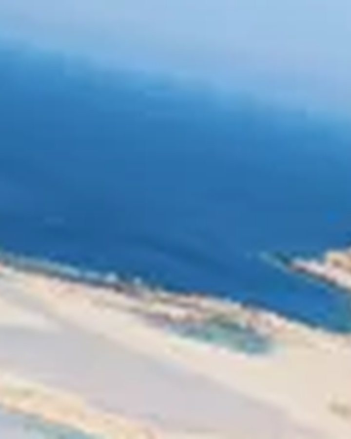 Crete: the Balos lagoon with its deep blue and turquoise water, a long spit of white sand and a rocky peninsula