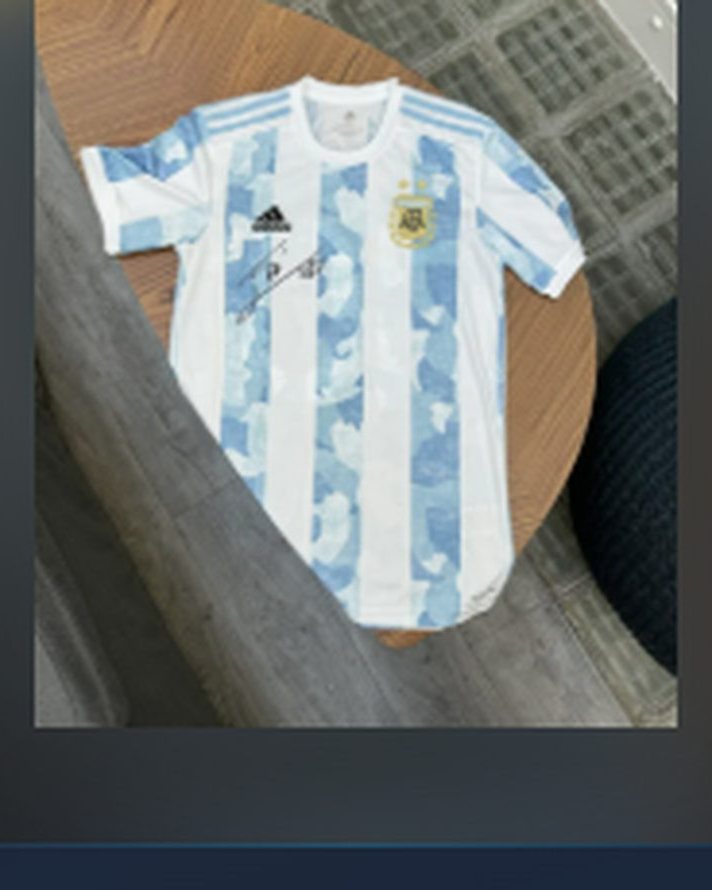 Official 2021 Argentina national team jersey, printed and hand-signed by Lionel Messi, shown laid flat